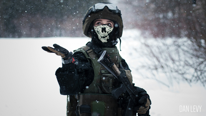 Person in tactical gear and skull mask in snow