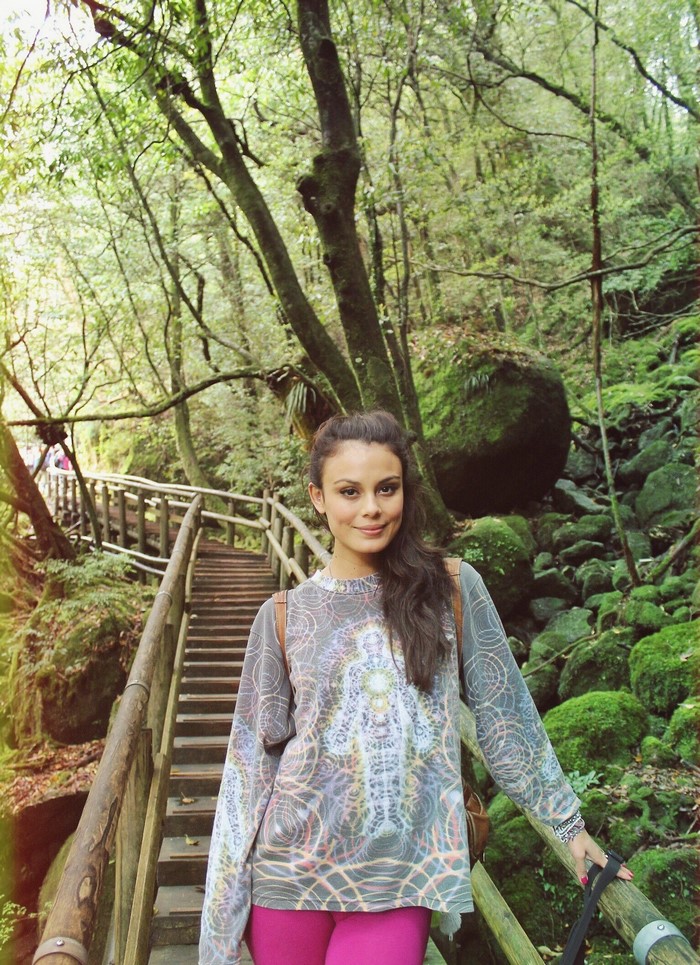 Nathalie Kelley in a forest with wooden stairs