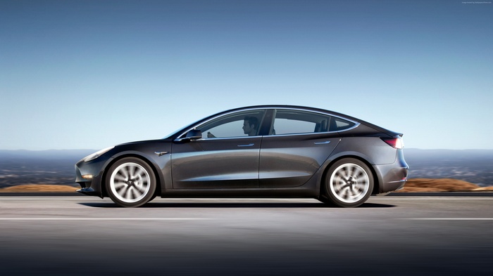 Tesla Model S electric car driving on road