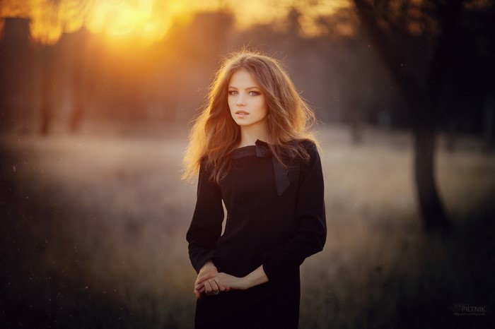 Woman in black dress in sunlight