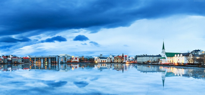 Reykjavik skyline with church reflected in frozen water