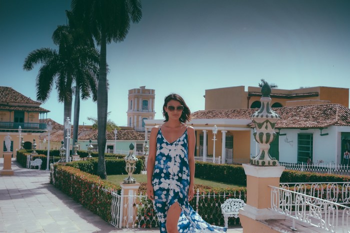 Nathalie Kelley in a blue and white dress in Trinidad