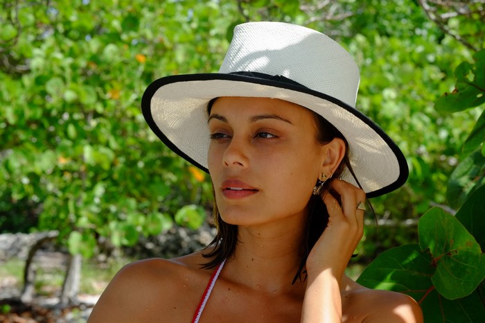 Nathalie Kelley wearing a white hat and bikini
