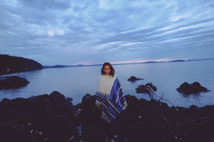 Nathalie Kelley by the sea at dusk