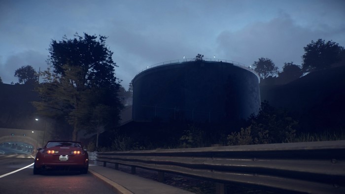 Red Toyota Supra on a highway at dusk