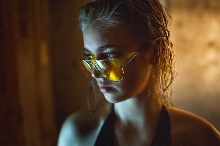 Woman wearing yellow aviator sunglasses