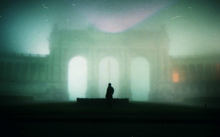 Silhouette in front of a foggy building