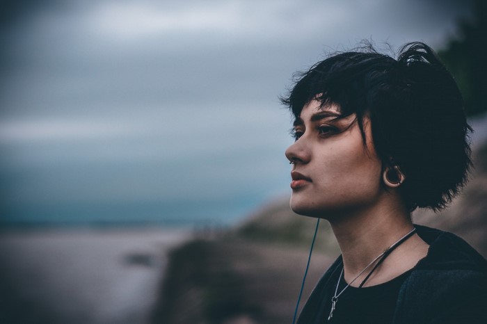 Woman with short black hair looking away