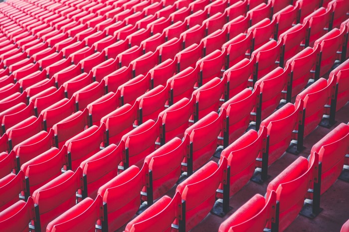 Rows of empty red stadium seats