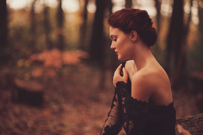 Woman in black dress in autumn forest