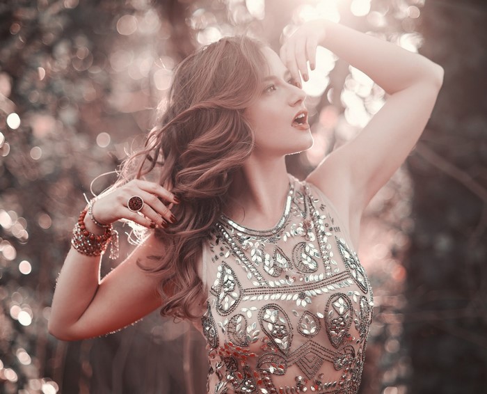 Woman in a beaded dress with jewelry outdoors