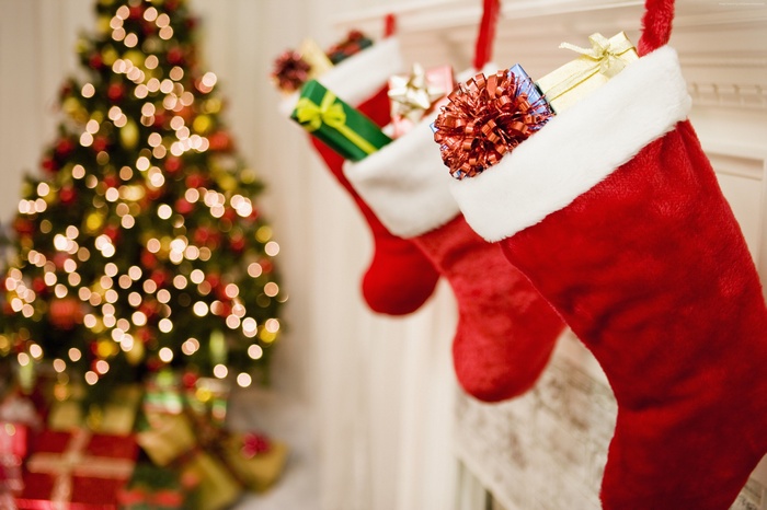 Christmas stockings filled with gifts by a tree