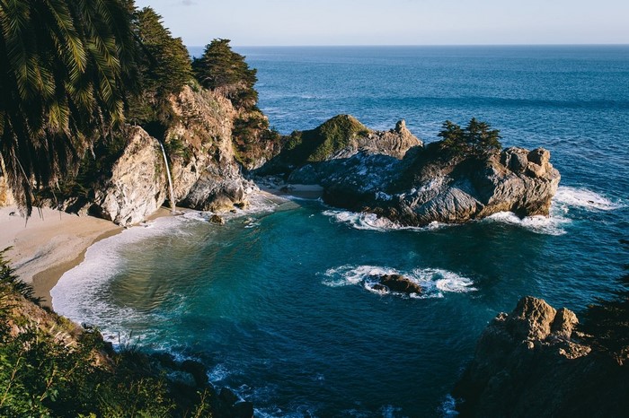 McWay Falls waterfall cascading onto a sandy beach in Big Sur