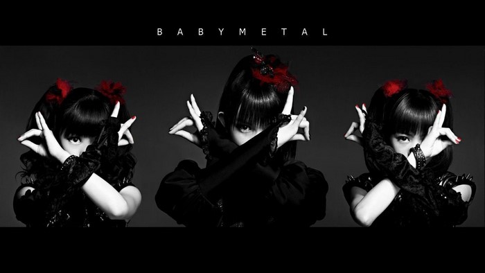 BABYMETAL members in black costumes with red accents