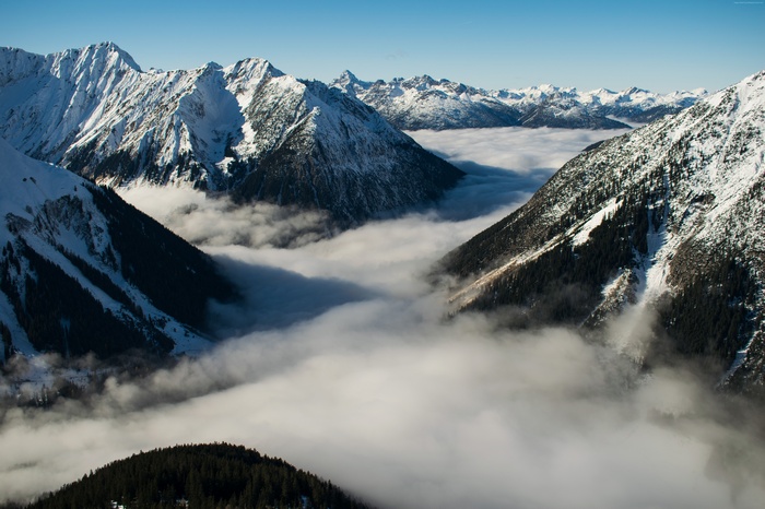 Snow-capped mountains above clouds in Switzerland