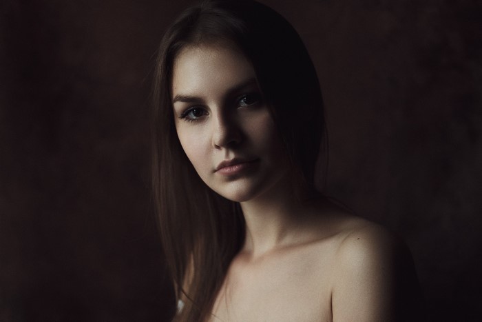 Portrait of a young woman with long brown hair