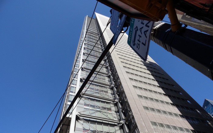 Skyscraper with Bike Lane Sign and Power Lines