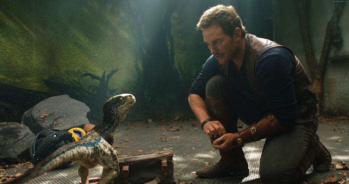 Chris Pratt with a baby dinosaur in Jurassic World: Fallen Kingdom