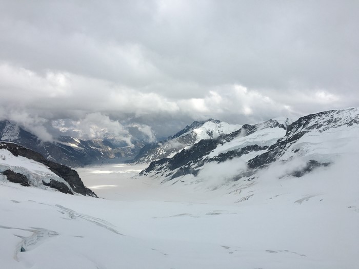Snowy mountain range with clouds