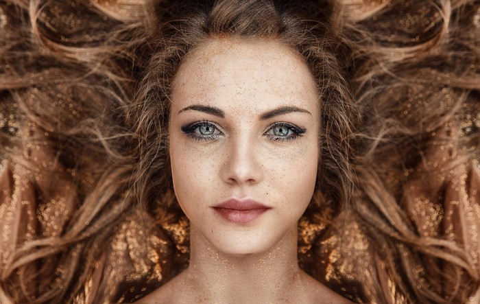 Portrait of Woman with Freckles and Blue Eyes