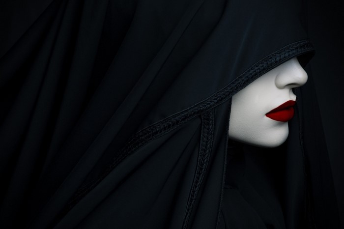 Woman in black veil with red lipstick