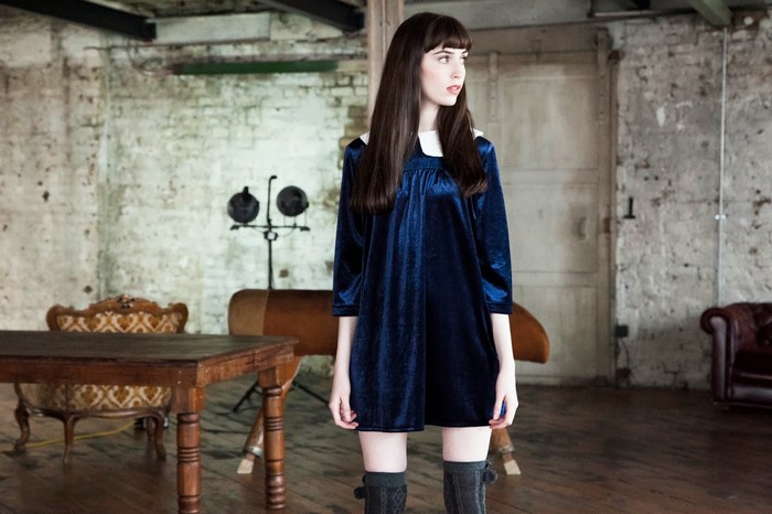 Sorcha P model in blue velvet dress and knee-high boots
