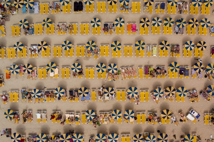 Aerial view of beach with deck chairs and umbrellas