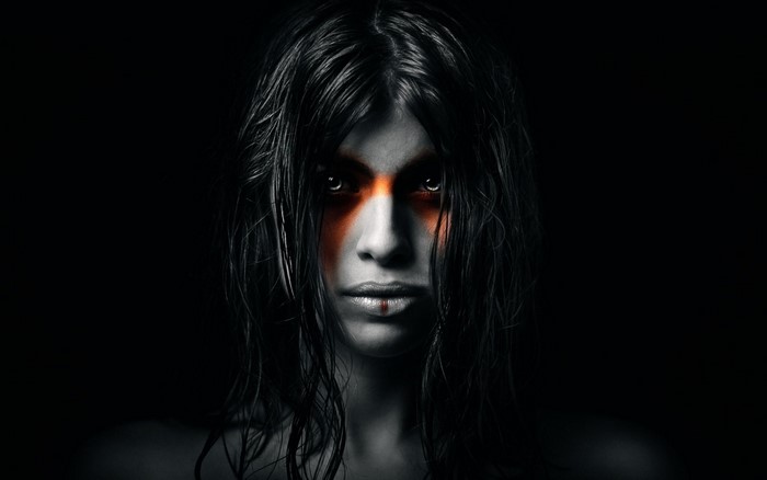 Woman with orange face paint and black hair