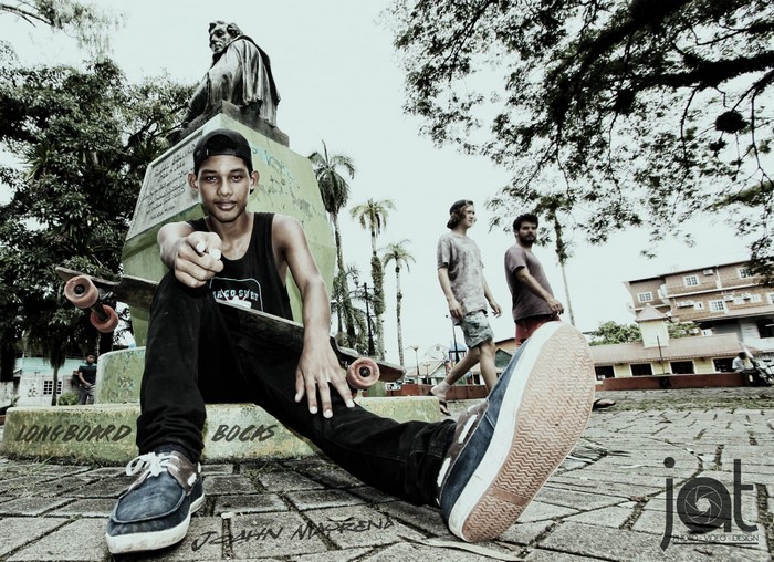Young man with longboard in Bocas Town, Panama