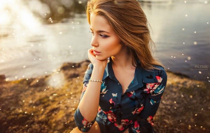 Woman with long brown hair in a floral dress