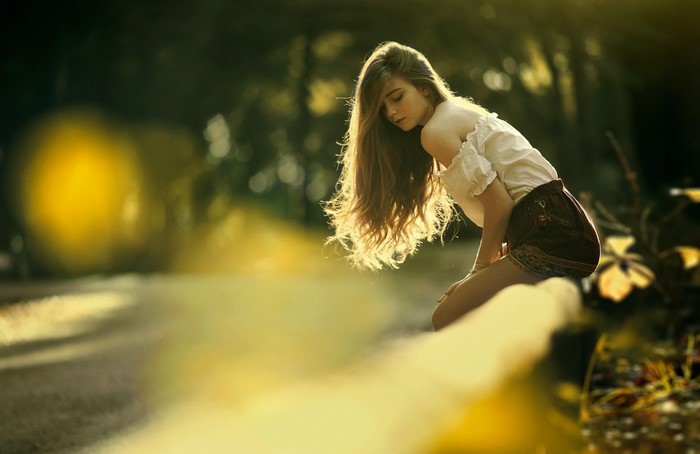 Young woman with long hair in sunlight outdoors