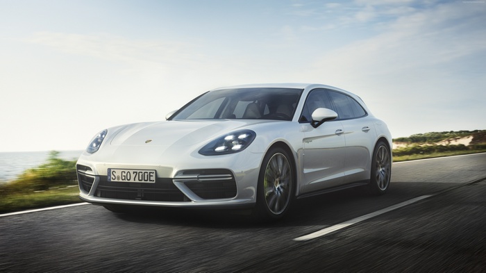 White Porsche Panamera Turbo S E-Hybrid Sport Turismo driving on road