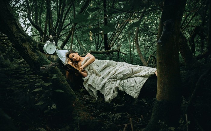 Woman Resting on Tree in Enchanted Forest