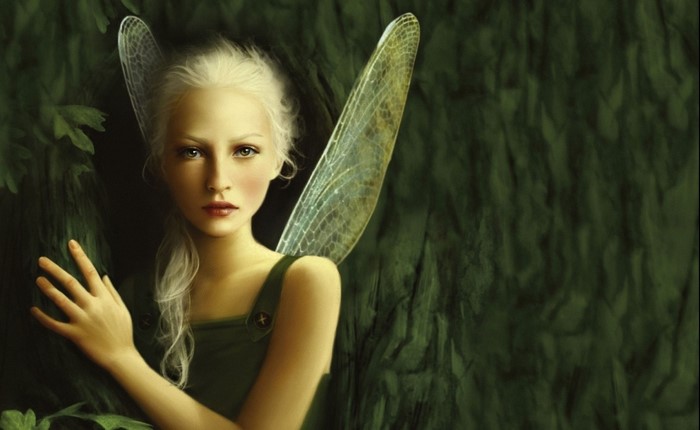 Fairy with wings in a green forest
