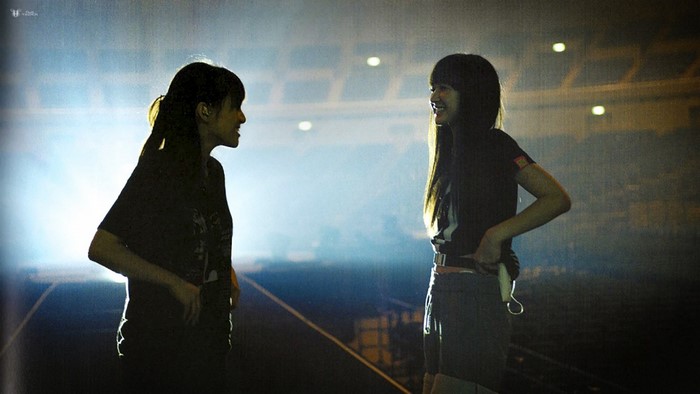 Perfume members on stage during a concert