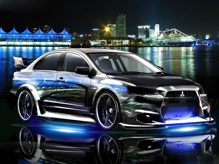 Modified Mitsubishi Lancer Evolution sedan with cityscape at night