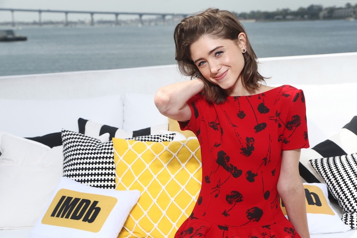 Natalia Dyer posing with IMDb pillows