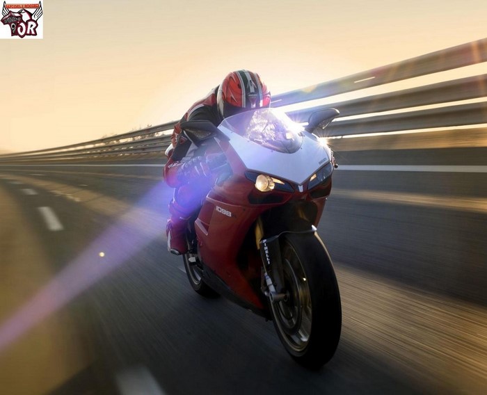 Ducati motorcycle rider on a highway at sunset