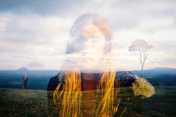Double exposure of a woman and a landscape