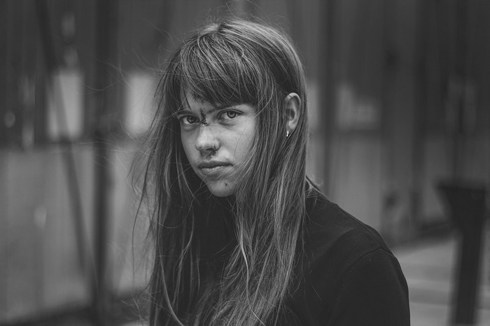 Monochrome portrait of a young woman with windblown hair