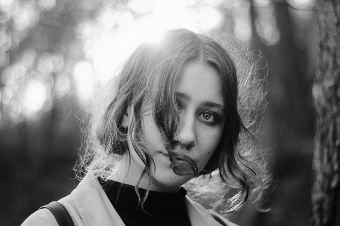 Monochrome portrait of a young woman with wavy hair