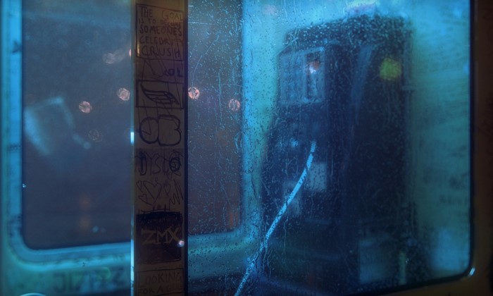Graffiti on a rainy phone booth