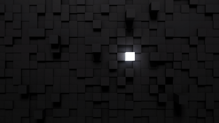 Monochrome pattern of black cubes with one illuminated white cube