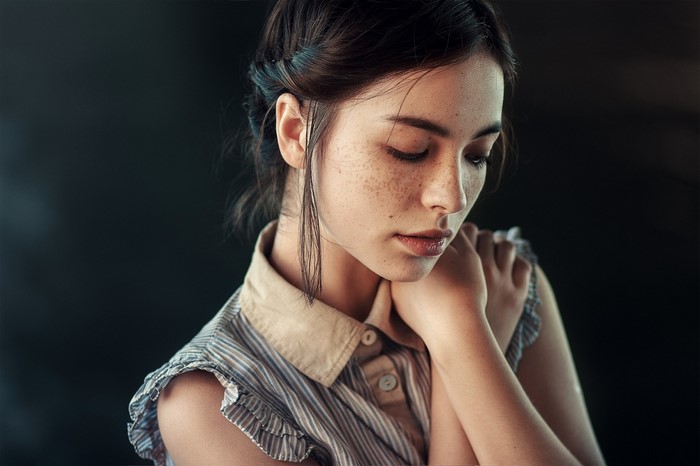 Portrait of a young woman with freckles