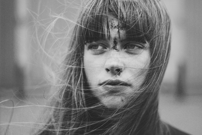 Monochrome portrait of a woman with hair in her face
