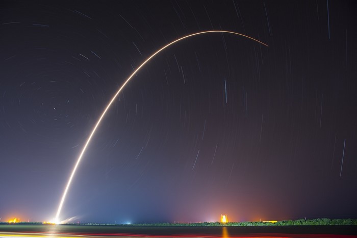 Rocket launch trail against starry night sky