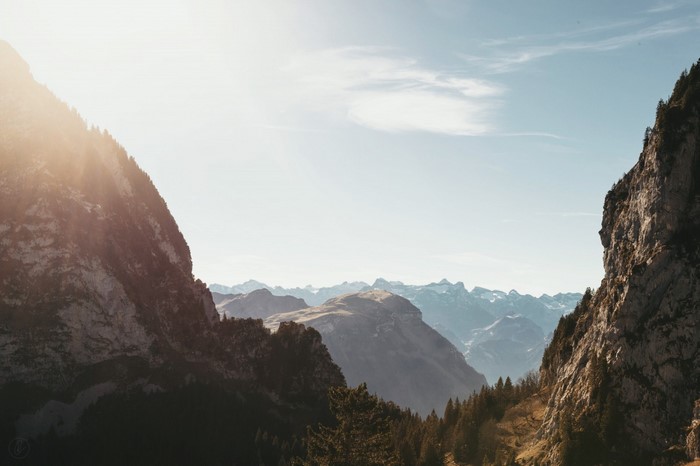 Sunlight over a mountain valley with rocky cliffs