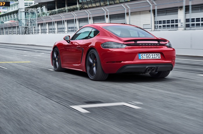Red Porsche 718 Cayman GTS on a race track