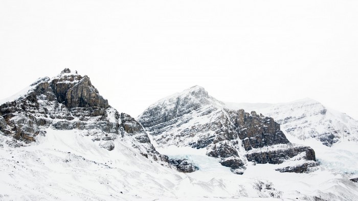 Snow-covered mountains and glaciers under a bright sky