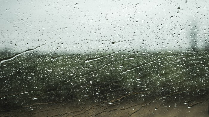 Raindrops on a window with a blurred background